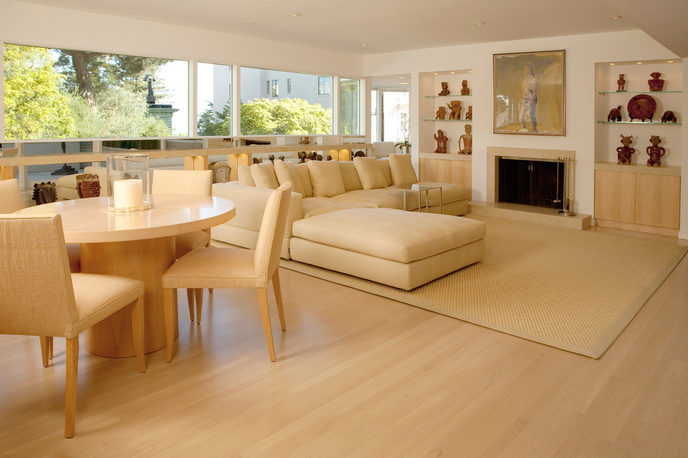Trendy light wood floor family room photo in San Francisco with white walls, a standard fireplace and a stone fireplace