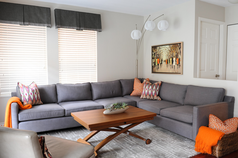 Example of a small trendy open concept medium tone wood floor family room design in Vancouver with gray walls, no fireplace and a wall-mounted tv
