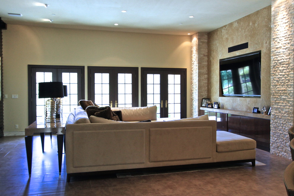 Large trendy open concept porcelain tile family room photo in Orange County with beige walls, no fireplace and a media wall