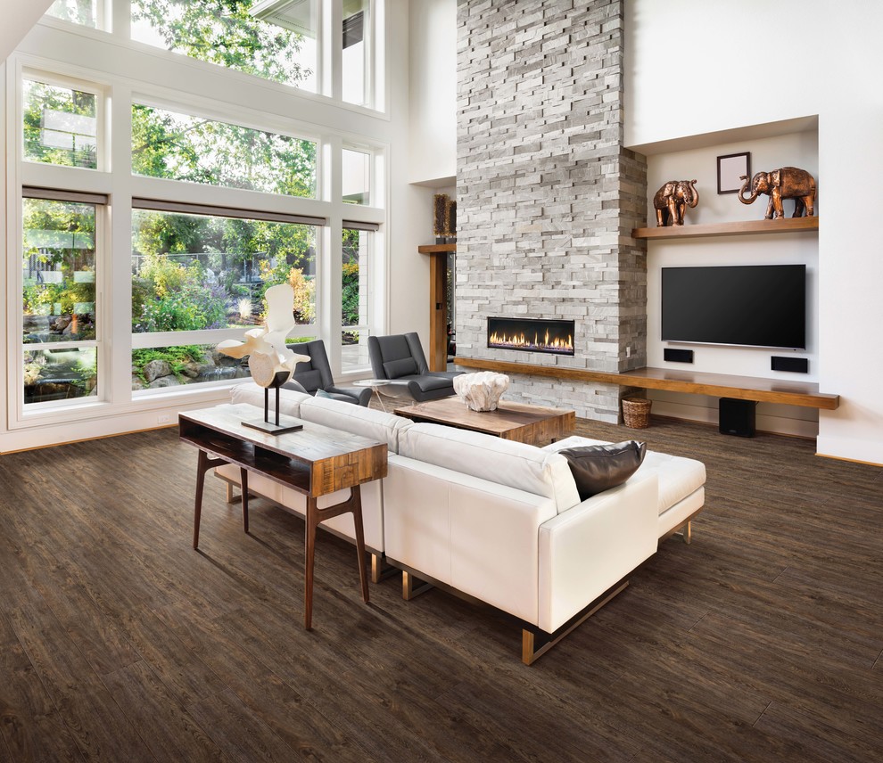 Inspiration for a large contemporary open concept vinyl floor and brown floor family room remodel in Sacramento with white walls, a ribbon fireplace, a stone fireplace and a wall-mounted tv