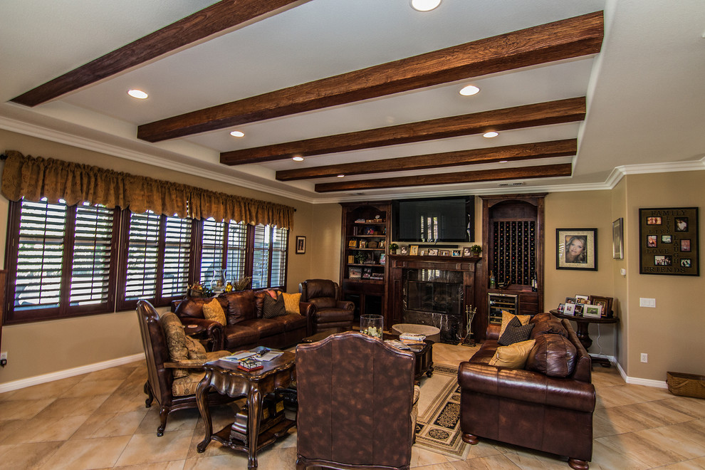 Design ideas for a large traditional mezzanine games room in Los Angeles with beige walls, travertine flooring, a standard fireplace and a wooden fireplace surround.