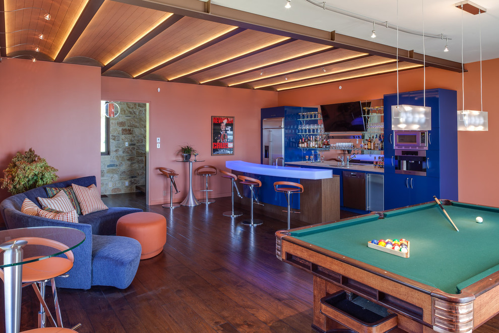 Photo of a large contemporary games room in San Francisco with dark hardwood flooring, no fireplace, a wall mounted tv and orange walls.
