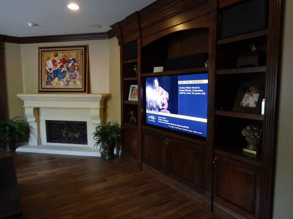 Example of a mid-sized transitional family room design in Orange County with beige walls, a corner fireplace and a media wall