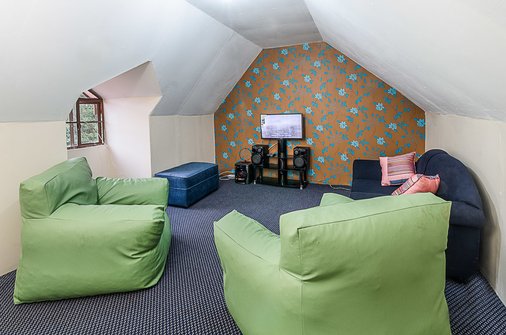Cette photo montre une petite salle de séjour moderne fermée avec un mur multicolore, moquette, aucune cheminée, un téléviseur indépendant et un sol bleu.