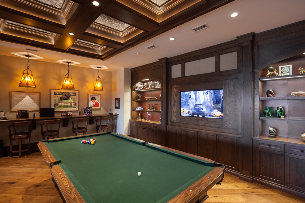 Rustic open plan games room in Calgary with beige walls, medium hardwood flooring and a built-in media unit.