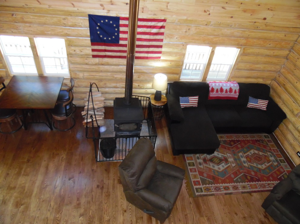 Modelo de sala de estar tipo loft rural de tamaño medio con paredes beige y suelo de madera en tonos medios