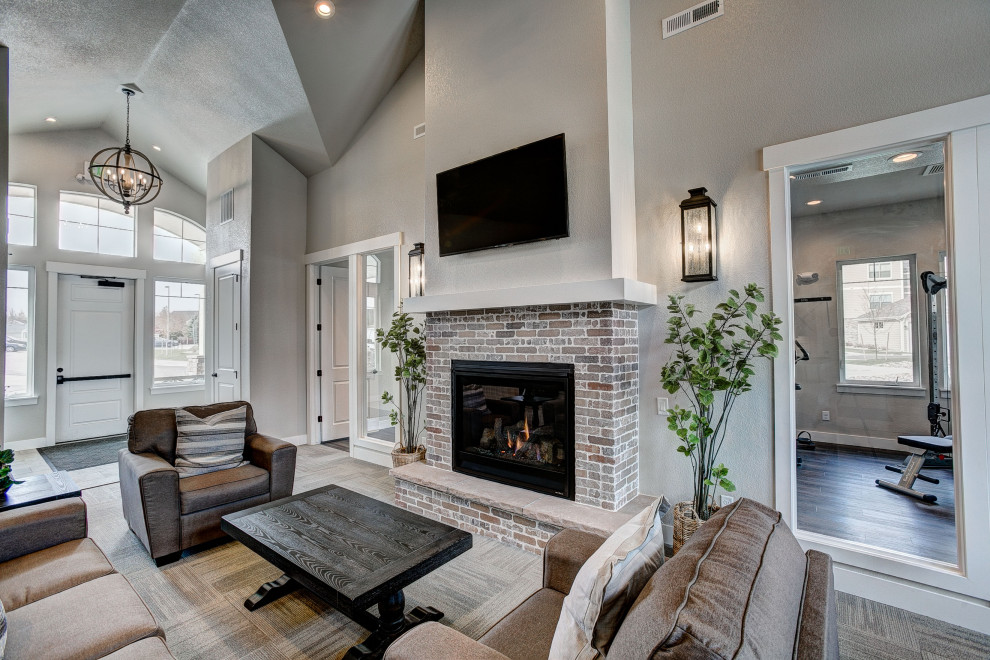 Inspiration for a mid-sized eclectic open concept dark wood floor and brown floor family room remodel in Denver with a bar, gray walls, a standard fireplace, a tile fireplace and a media wall