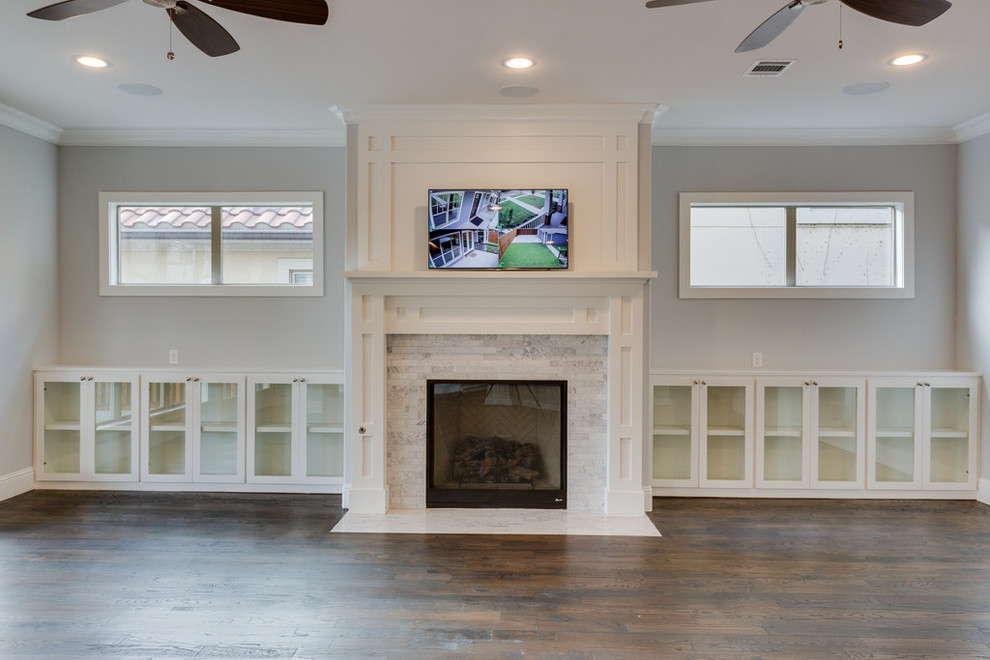Family room - large craftsman open concept medium tone wood floor family room idea in Dallas with beige walls, a standard fireplace, a tile fireplace and a wall-mounted tv
