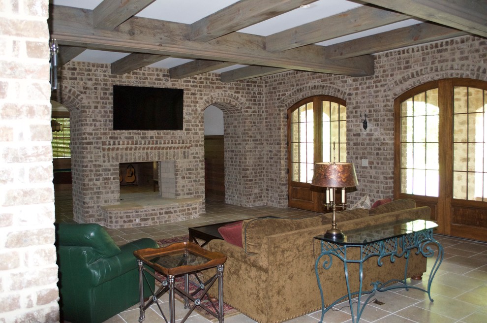 Réalisation d'une salle de séjour craftsman de taille moyenne et fermée avec un bar de salon, un mur beige, sol en béton ciré, une cheminée double-face, un manteau de cheminée en brique et un téléviseur fixé au mur.