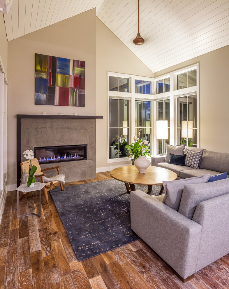 Ejemplo de sala de estar abierta de estilo de casa de campo sin televisor con paredes beige, suelo de madera en tonos medios, chimenea lineal, marco de chimenea de hormigón y suelo marrón