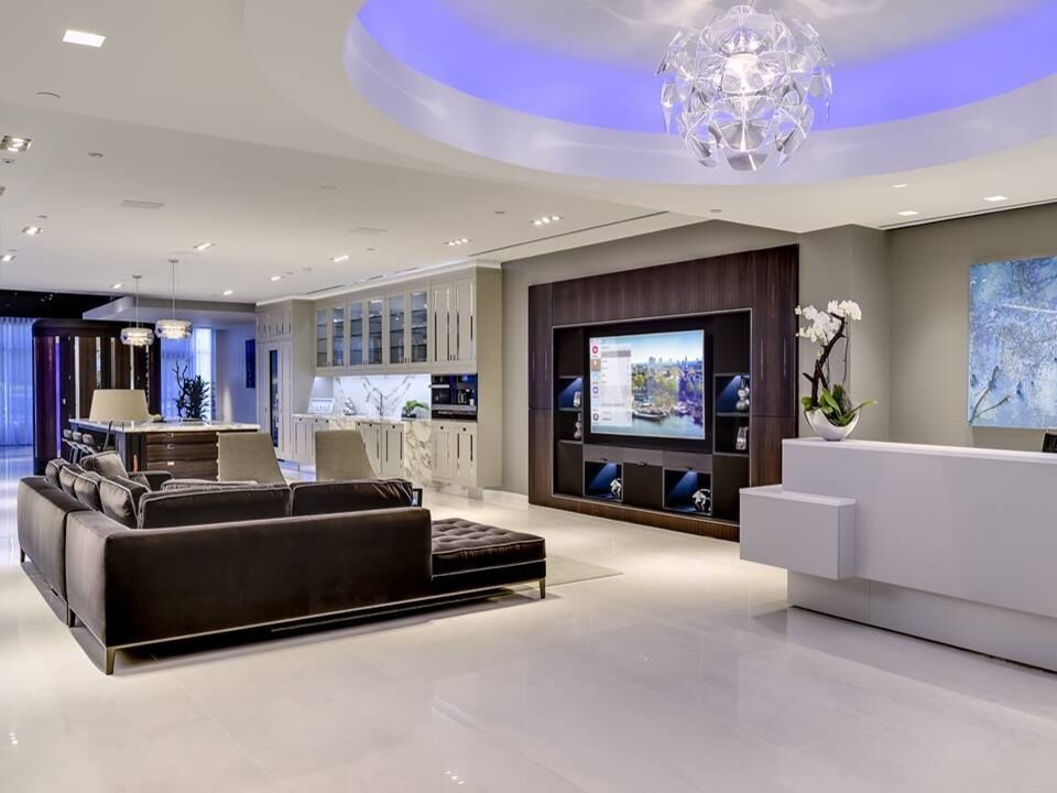 This is an example of a large contemporary open plan games room in Seattle with grey walls, porcelain flooring, a built-in media unit and white floors.