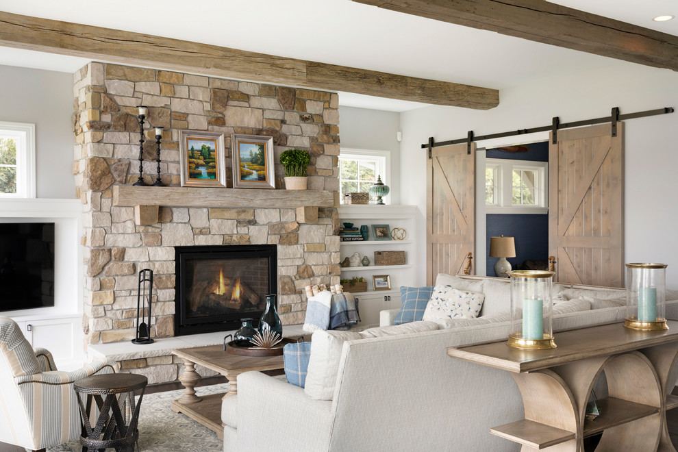 Inspiration for a beach style enclosed games room in Minneapolis with grey walls, a wood burning stove and a wall mounted tv.