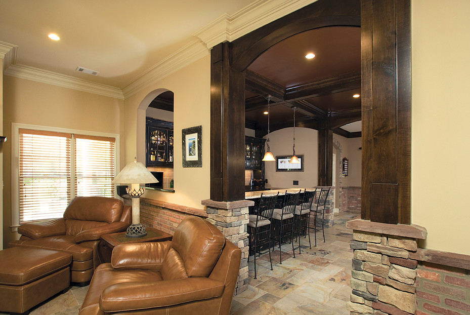 This is an example of a large rustic open plan games room in Atlanta with beige walls and slate flooring.