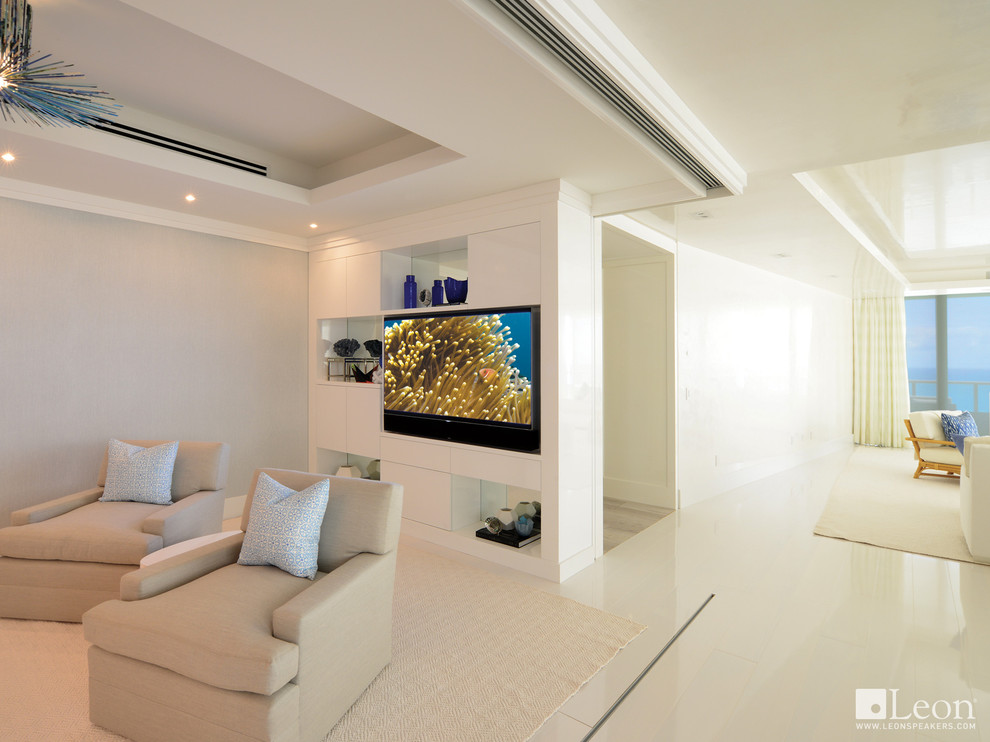 This is an example of a medium sized coastal open plan games room in Miami with white walls, porcelain flooring and a built-in media unit.