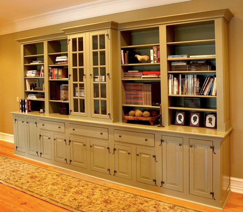 Foto de sala de estar con biblioteca abierta de estilo de casa de campo grande con paredes beige y suelo de madera en tonos medios