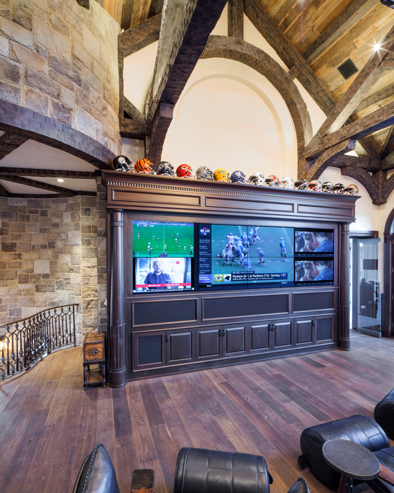 Esempio di un grande soggiorno country con sala giochi, pareti beige, pavimento in legno verniciato, parete attrezzata e pavimento marrone