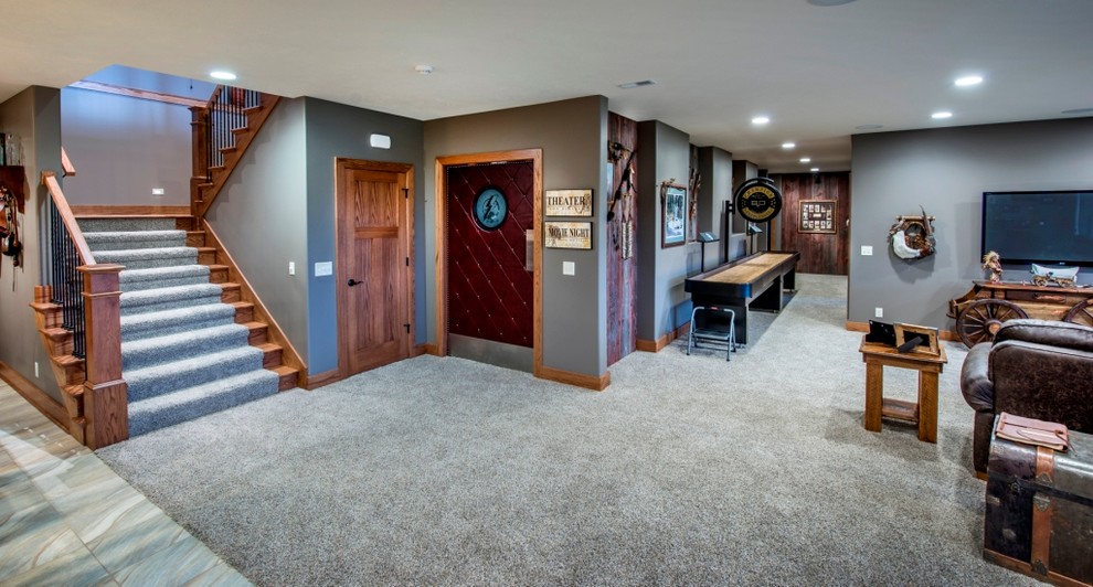 This is an example of a large traditional open plan games room in Omaha with a game room, grey walls, carpet and a wall mounted tv.