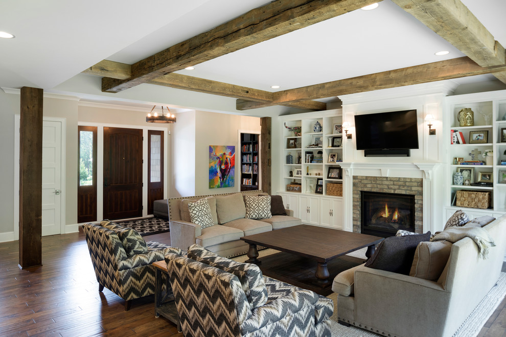 Großes, Offenes Klassisches Wohnzimmer mit grauer Wandfarbe, braunem Holzboden, Kamin, Kaminumrandung aus Stein und Multimediawand in Minneapolis