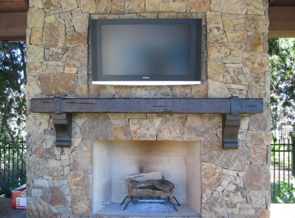 This is an example of a rustic games room in Dallas with a standard fireplace and a wooden fireplace surround.