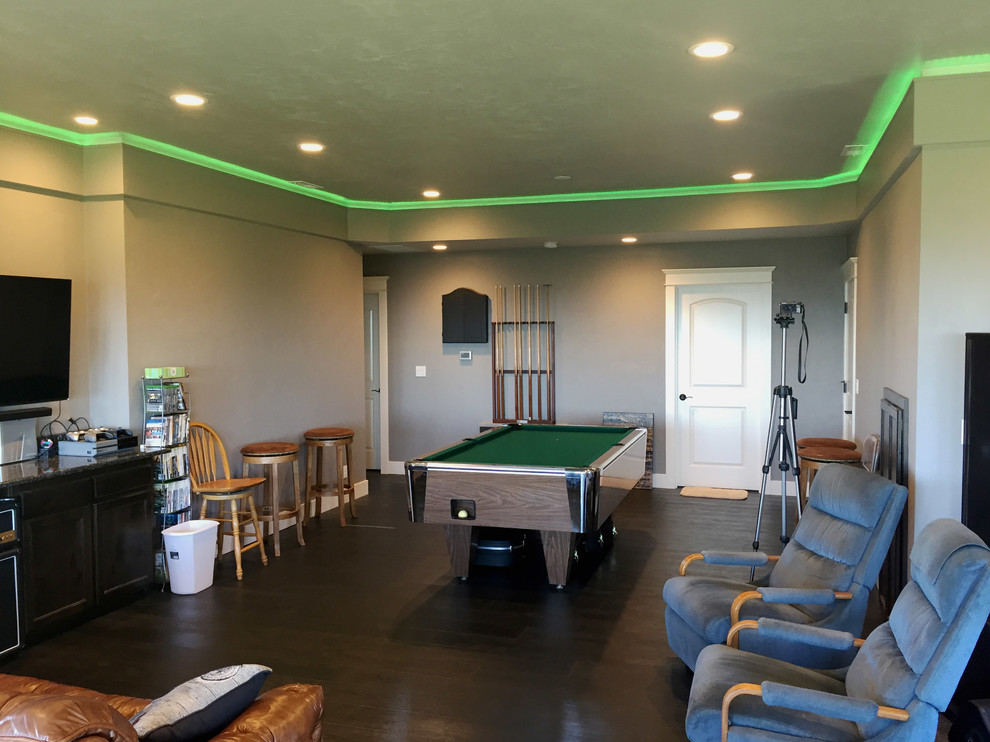Medium sized traditional open plan games room in Other with a game room, beige walls, vinyl flooring, a wall mounted tv and brown floors.