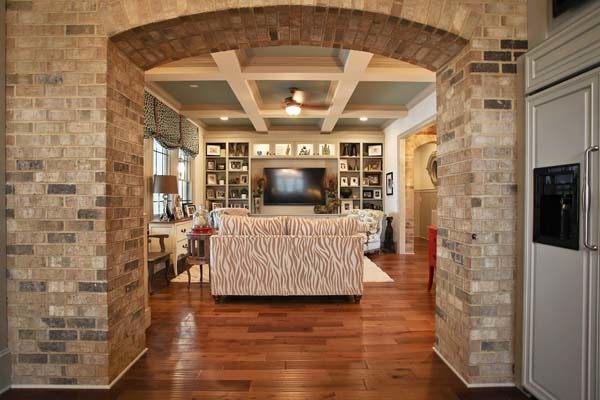 This is an example of a traditional open plan games room in Charlotte with medium hardwood flooring and a wall mounted tv.