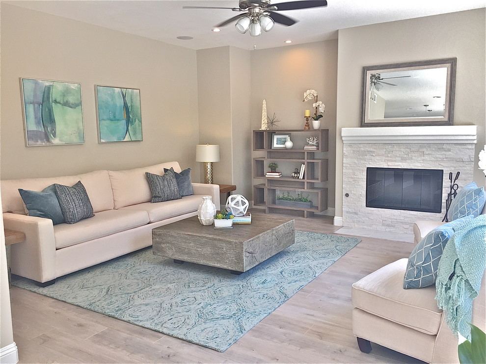 Mid-sized beach style open concept family room photo in Orange County with gray walls, a standard fireplace, a stone fireplace and no tv