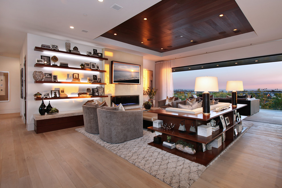 Photo of a large contemporary open plan games room in Orange County with white walls, light hardwood flooring, a ribbon fireplace, a wall mounted tv, beige floors, a metal fireplace surround and feature lighting.