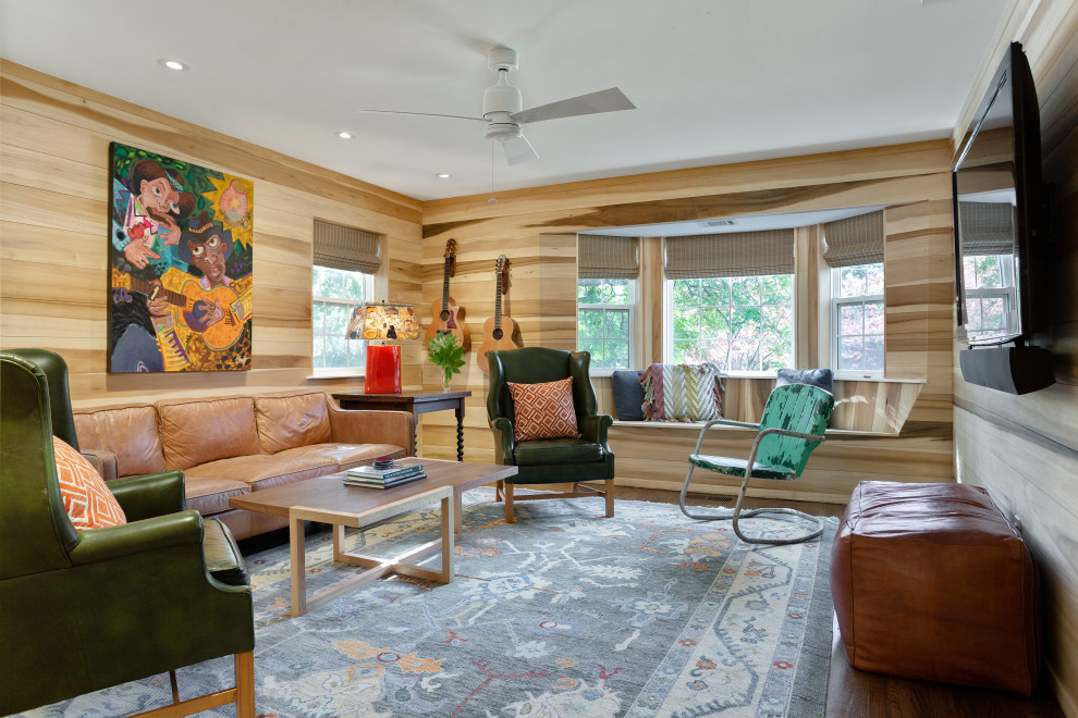 Small eclectic enclosed medium tone wood floor and brown floor family room photo in Dallas with brown walls and a wall-mounted tv