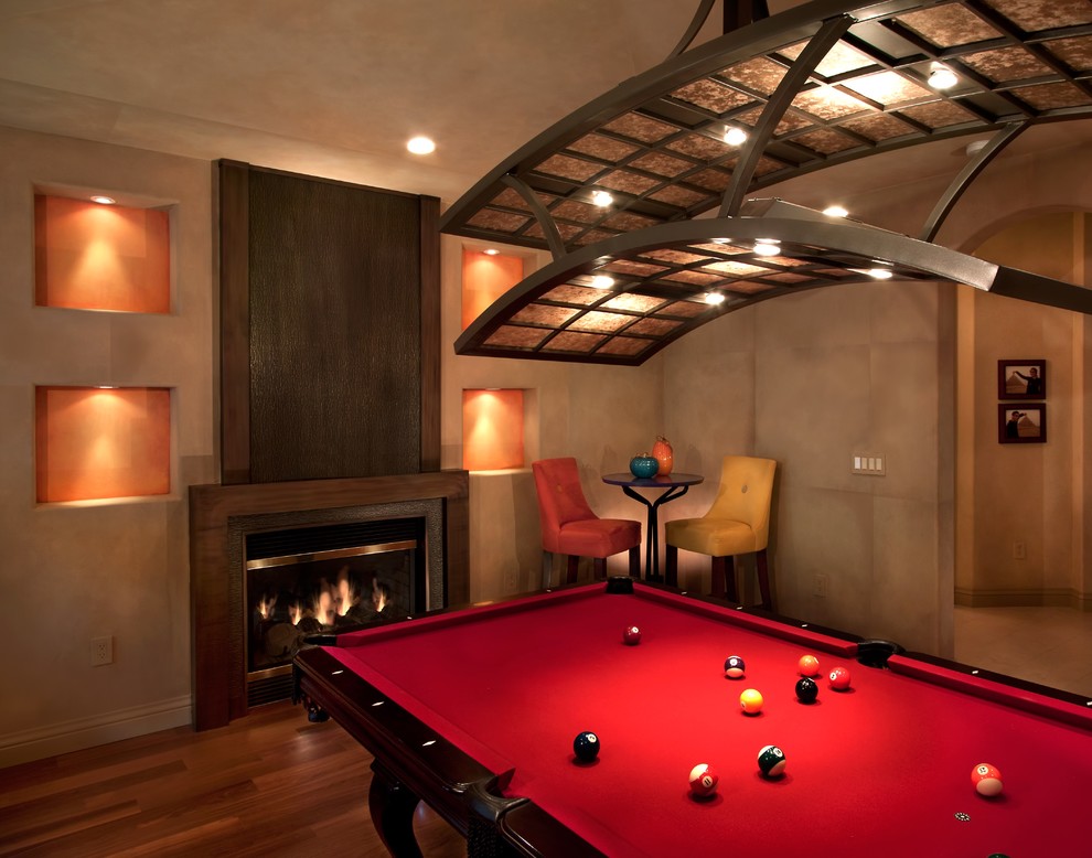 Design ideas for a contemporary enclosed games room in San Francisco with beige walls, dark hardwood flooring, a standard fireplace and no tv.