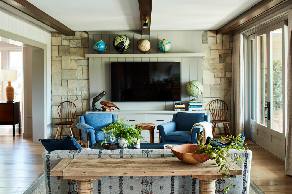 Example of a mid-sized beach style exposed beam and wall paneling living room design in Los Angeles