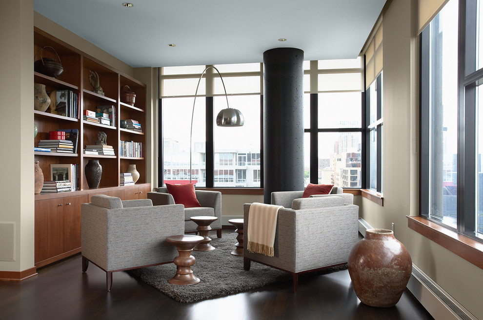 Example of a trendy open concept dark wood floor and brown floor family room library design in Minneapolis with beige walls, no fireplace and no tv