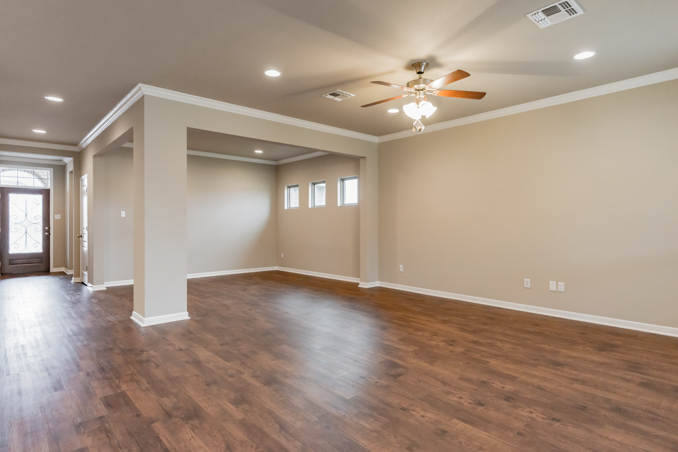 Mid-sized elegant open concept laminate floor and brown floor family room photo in Austin with beige walls, no fireplace and no tv