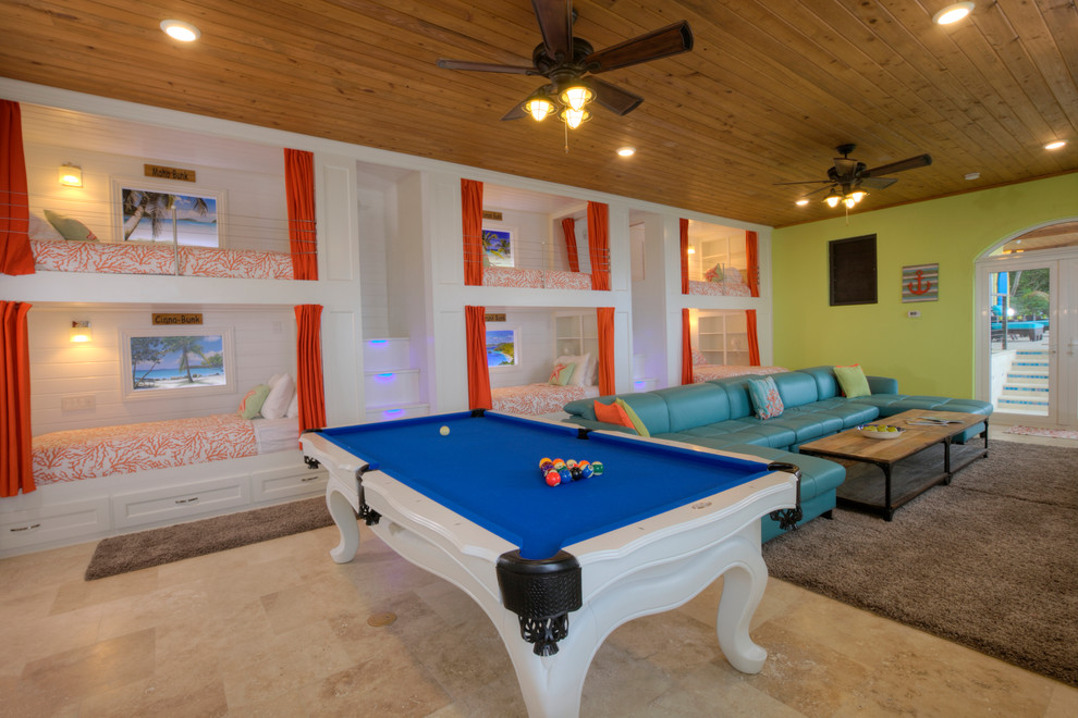 На фото: огромная открытая комната для игр в современном стиле с зелеными стенами, полом из травертина, телевизором на стене и бежевым полом