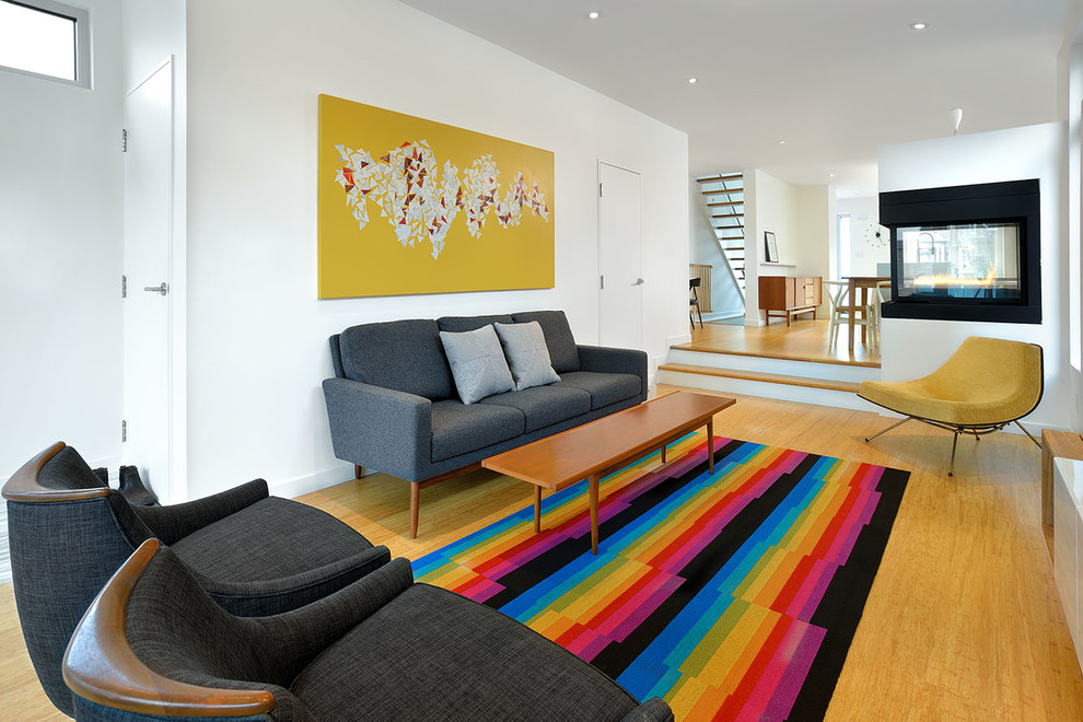 Immagine di un soggiorno minimal aperto con pareti bianche, camino bifacciale e pavimento giallo