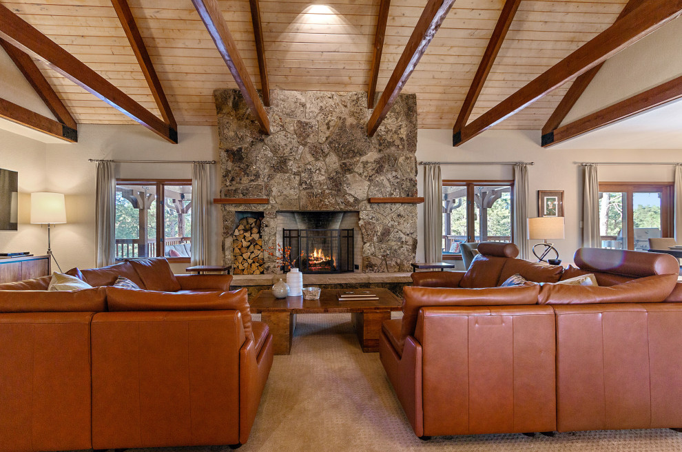 Family room - large contemporary open concept carpeted and beige floor family room idea in Denver with beige walls, a standard fireplace, a stone fireplace and a wall-mounted tv