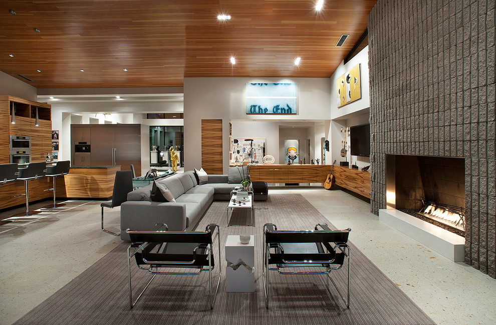 Diseño de sala de estar abierta contemporánea extra grande con paredes blancas, todas las chimeneas, marco de chimenea de piedra y televisor colgado en la pared