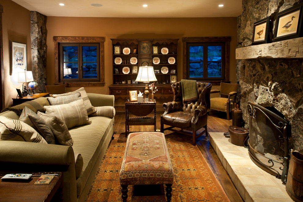 Mountain style family room photo in Denver with a stone fireplace
