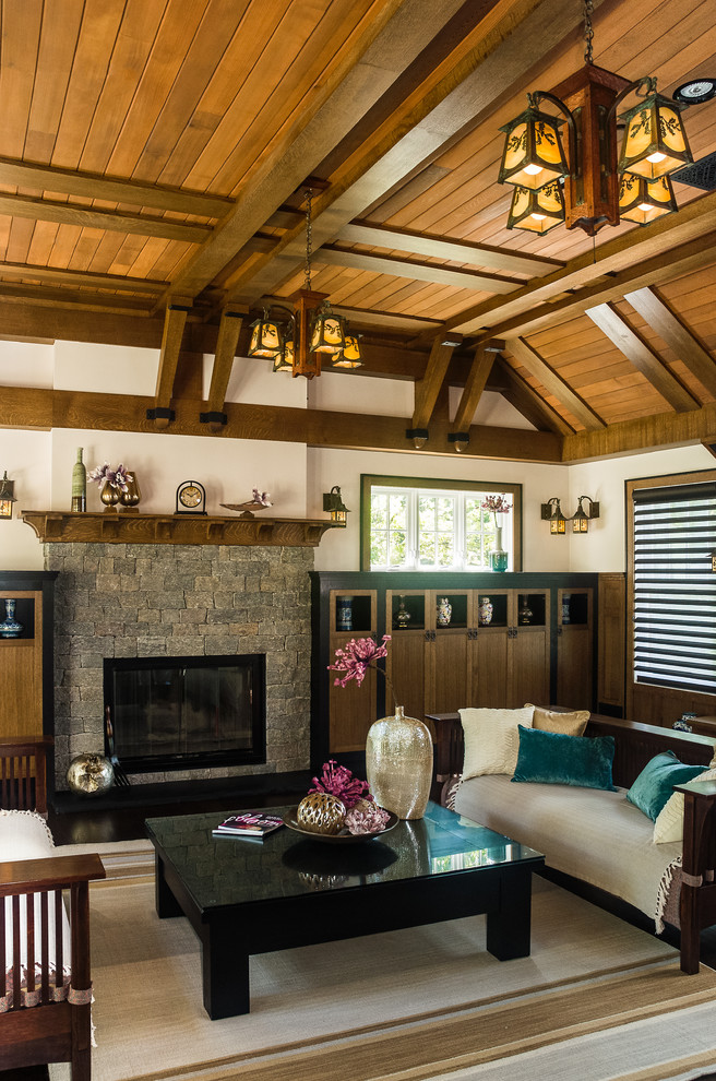 Inspiration for a mid-sized craftsman open concept dark wood floor family room remodel in New York with beige walls, a standard fireplace, a stone fireplace and a concealed tv