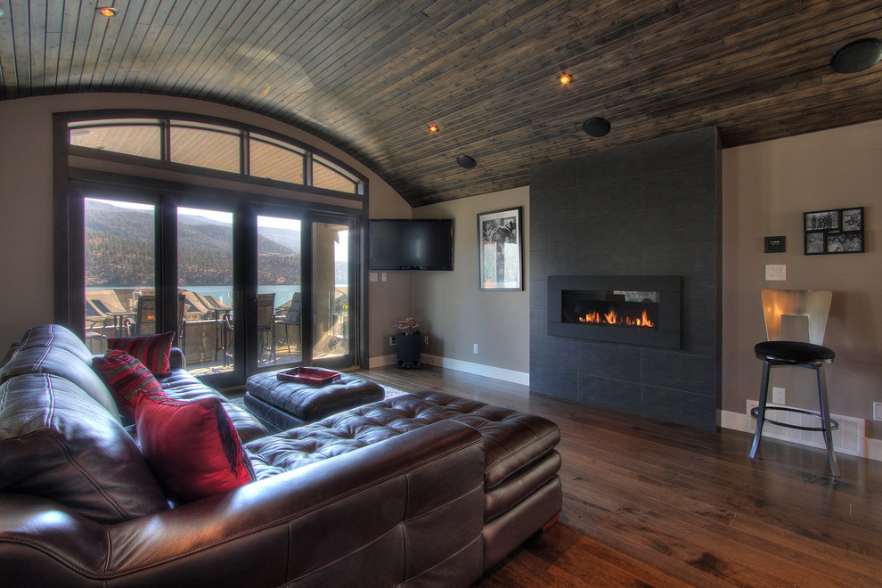 Mid-sized trendy dark wood floor and brown floor family room photo in Vancouver with brown walls, a ribbon fireplace, a tile fireplace and a corner tv