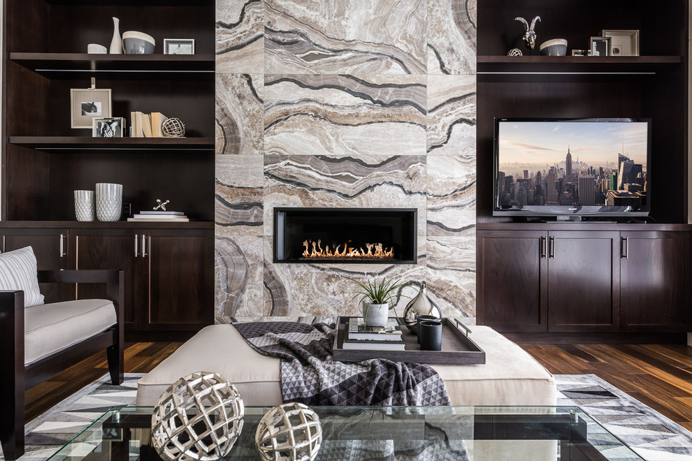 Family room library - mid-sized transitional enclosed dark wood floor family room library idea in Calgary with gray walls, a ribbon fireplace, a media wall and a tile fireplace