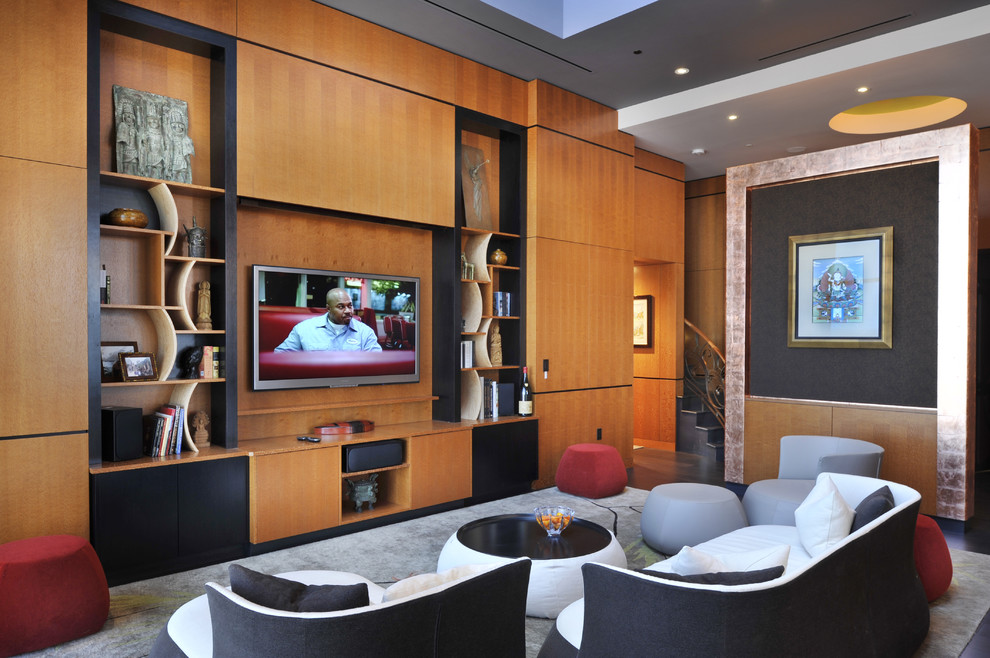 Idée de décoration pour une grande salle de séjour design avec un téléviseur encastré.