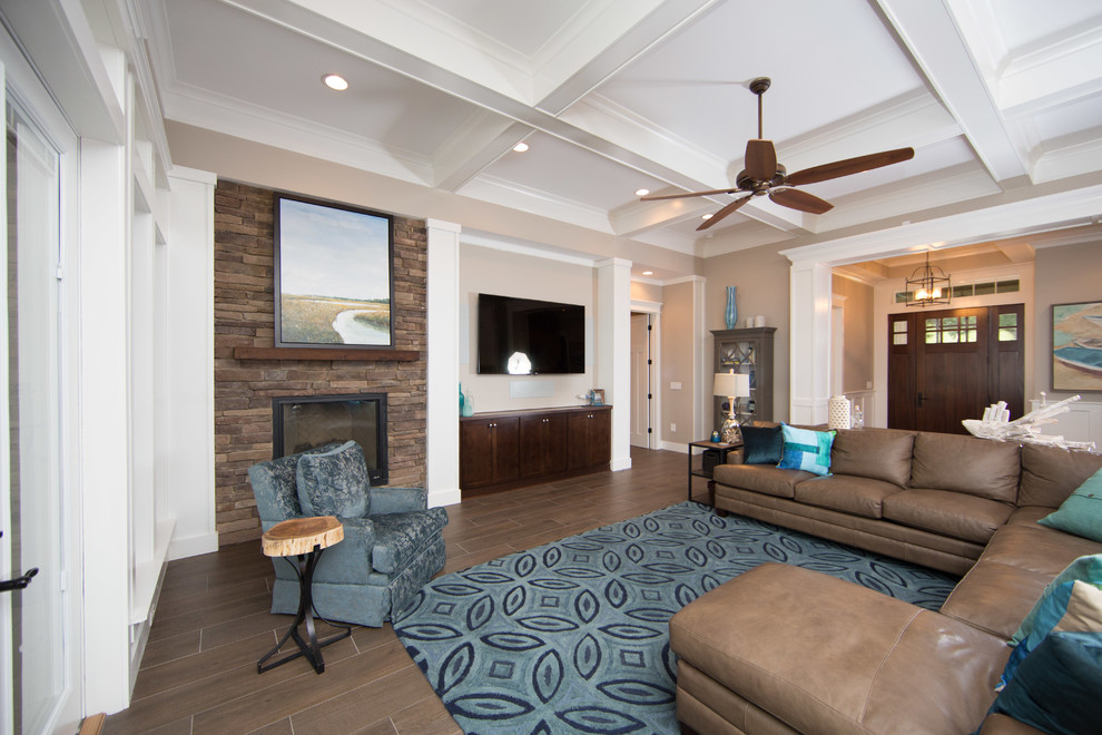Photo of a large rustic open plan games room in Jacksonville with grey walls, porcelain flooring, a standard fireplace, a stone fireplace surround and a wall mounted tv.