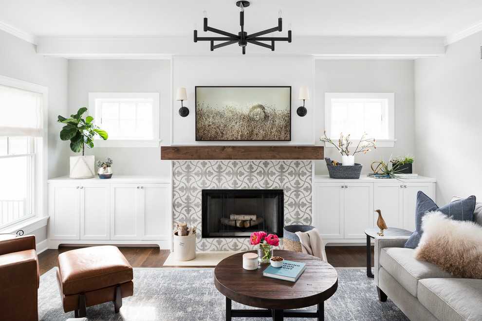 Large traditional open plan games room in Chicago with grey walls, medium hardwood flooring, a standard fireplace, a concrete fireplace surround, a wall mounted tv and brown floors.