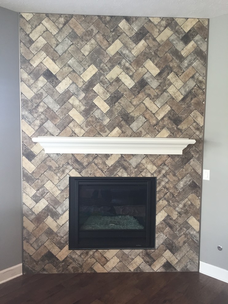 Design ideas for a medium sized games room in Indianapolis with multi-coloured walls, dark hardwood flooring and a corner fireplace.
