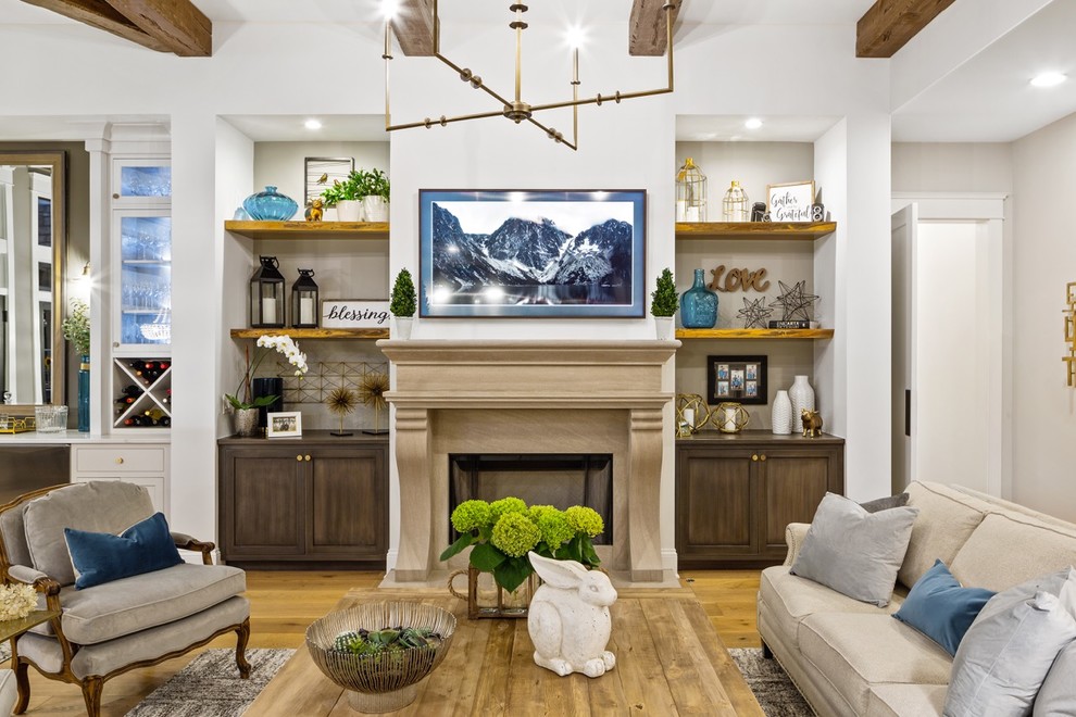 Foto de sala de estar abierta clásica renovada de tamaño medio con paredes grises, suelo de madera en tonos medios, todas las chimeneas, marco de chimenea de piedra y televisor colgado en la pared