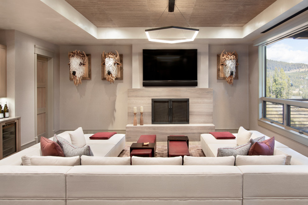 Example of a mountain style family room design in New York with white walls, a standard fireplace, a stone fireplace, a wall-mounted tv and a bar