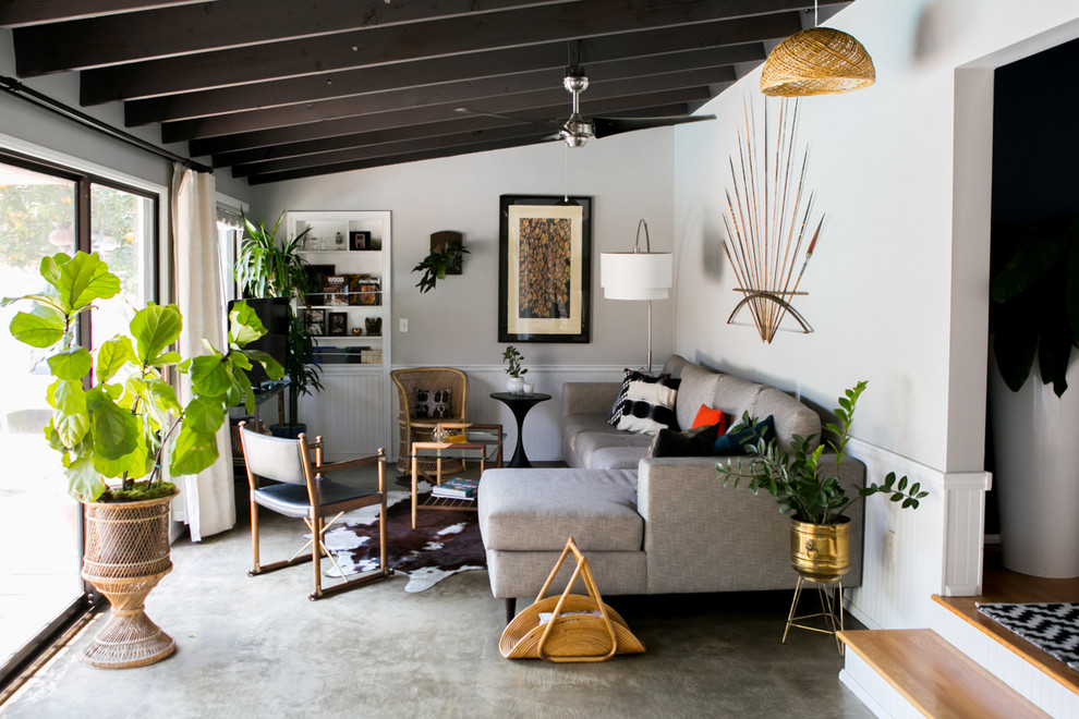 Großes, Abgetrenntes Stilmix Wohnzimmer ohne Kamin mit grauer Wandfarbe, Betonboden und Eck-TV in Los Angeles