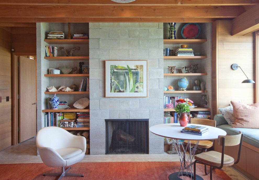 Inspiration for a large coastal open concept concrete floor family room library remodel in Boston with a standard fireplace, beige walls, a stone fireplace and no tv