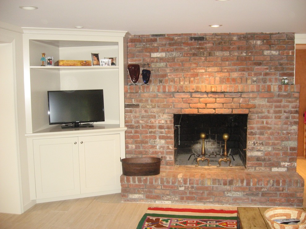 Example of a mid-sized eclectic enclosed porcelain tile family room design in New York with white walls, a standard fireplace and a corner tv