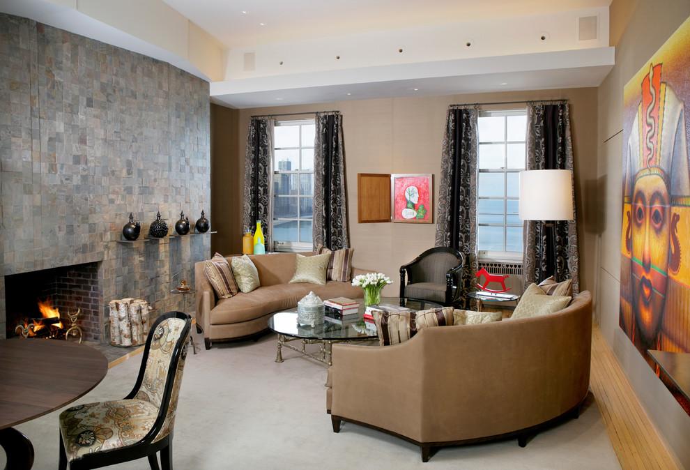 Idée de décoration pour une salle de séjour design avec un mur beige, une cheminée standard, un manteau de cheminée en pierre et aucun téléviseur.